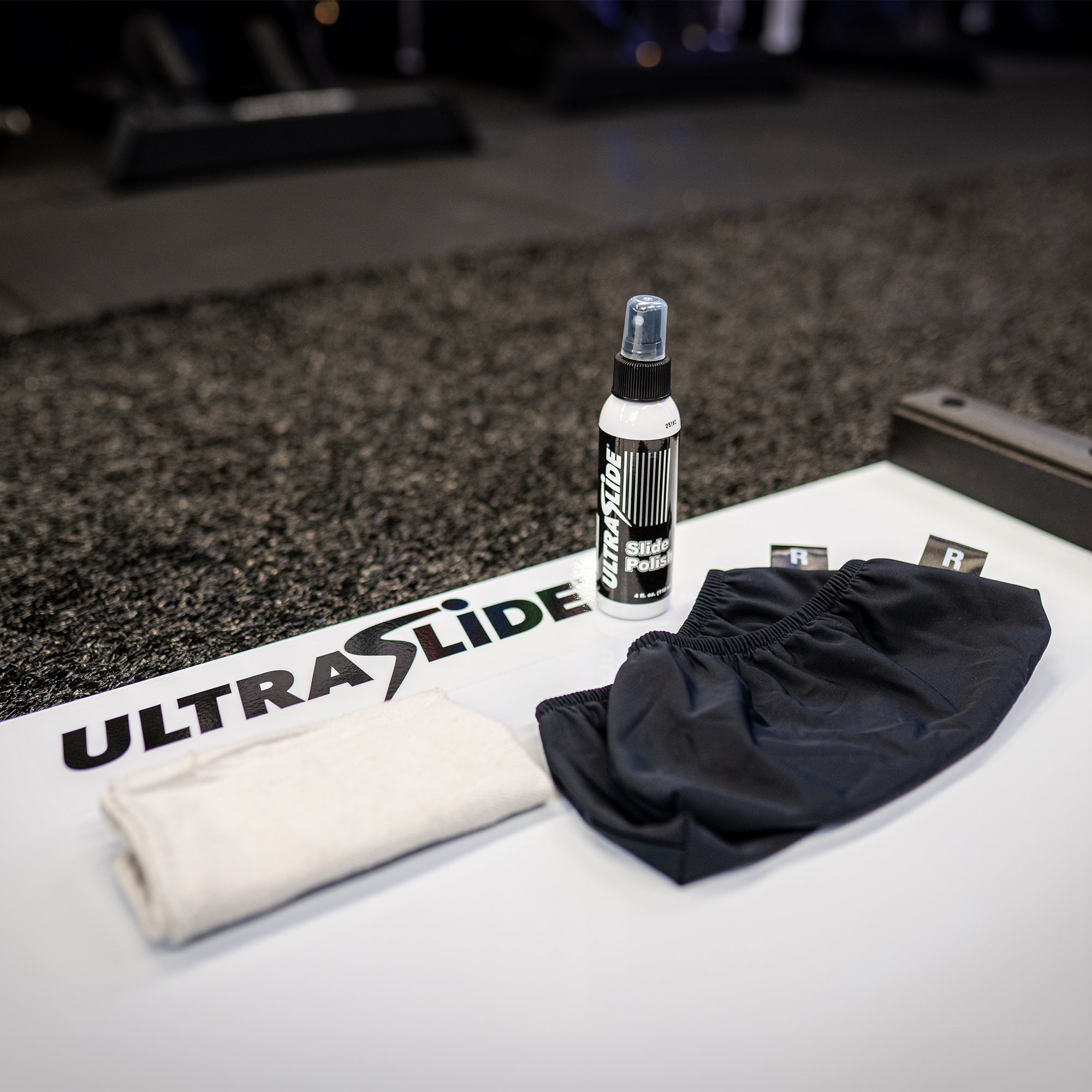ULTRASLIDE slide board and accessories on a gym floor