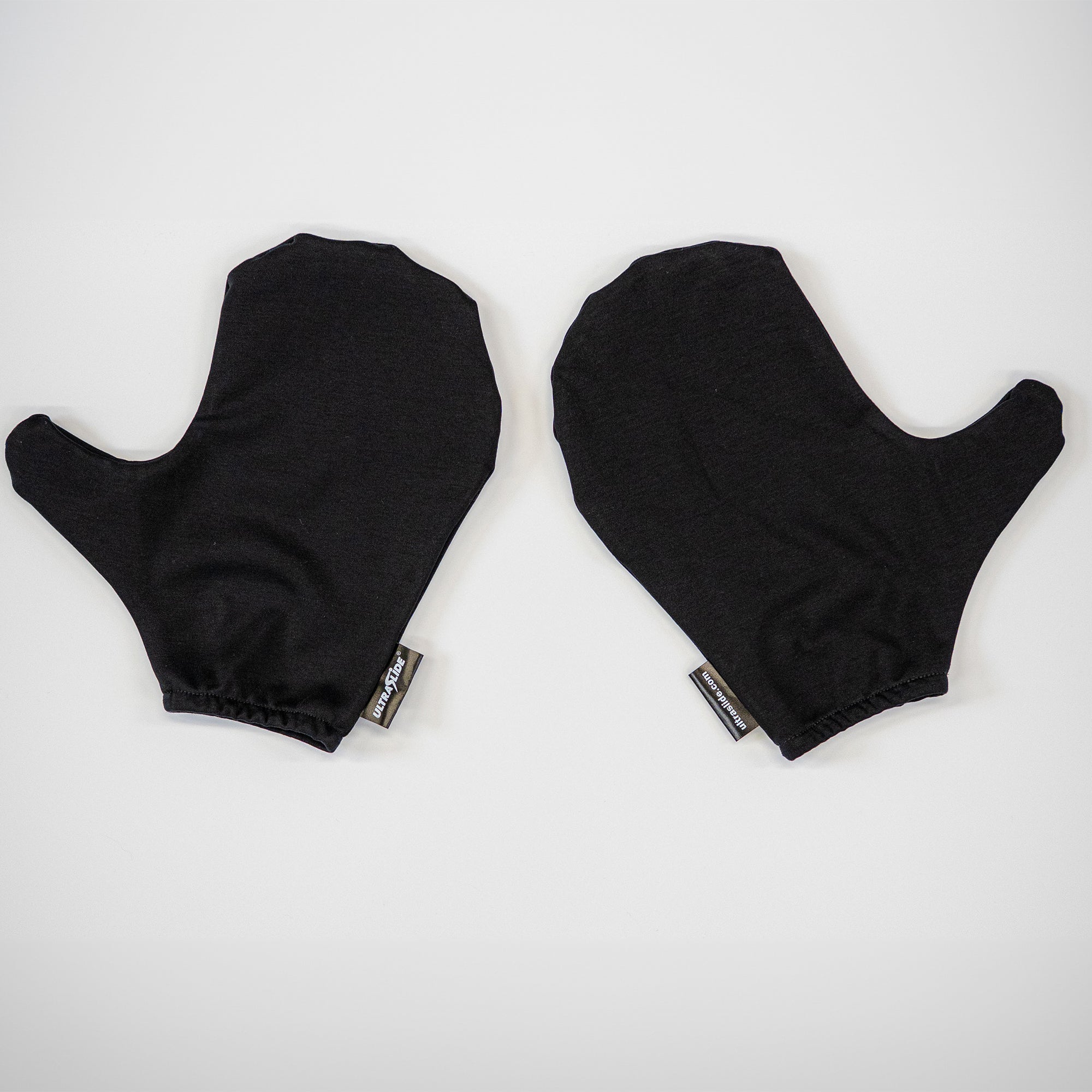 Pair of black ULTRALSLIDE slide board mitts on a white slide board