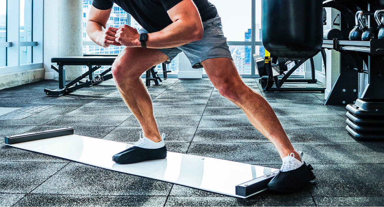 Person using an Ultraslide 6 slideboard in a gym setting